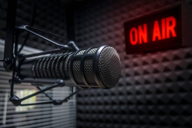 Professional microphone in a radio studio with an ON AIR sign